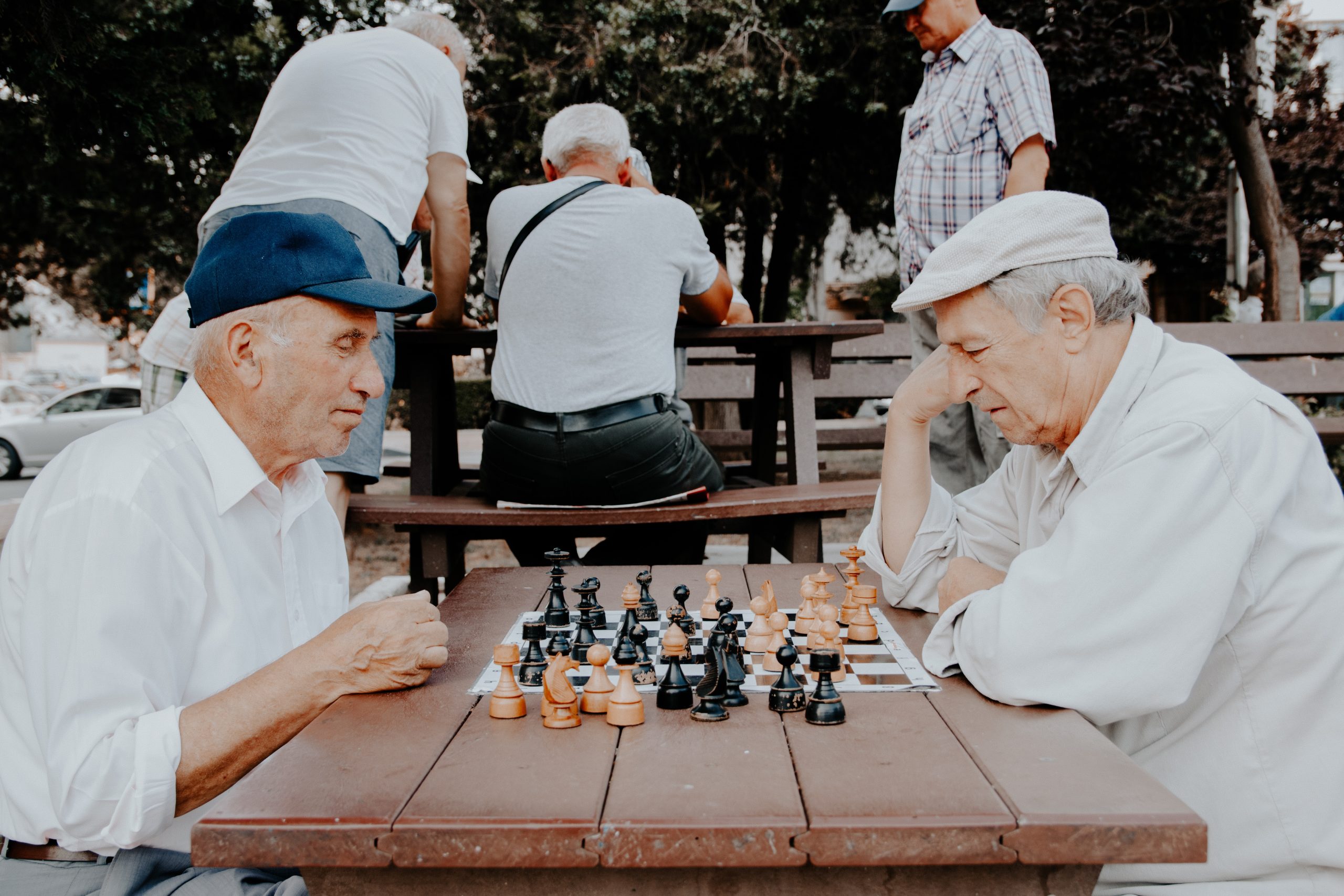 two men from baby boomer generation playing chess