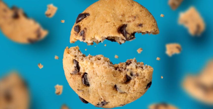 Falling broken chocolate chip cookies isolated on blue background with clipping path, flying biscuits collection