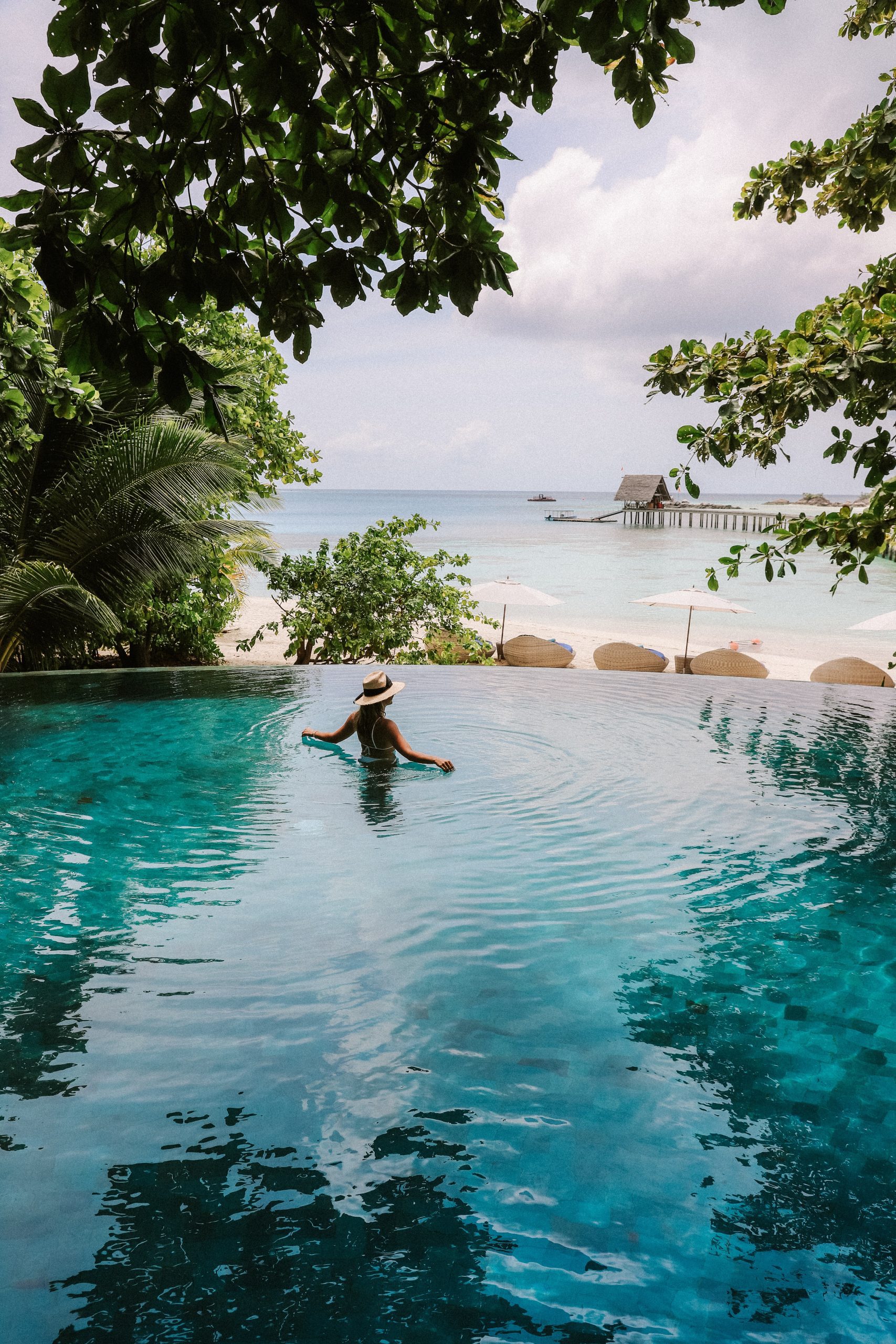 woman in a pool at a hotel on vacation